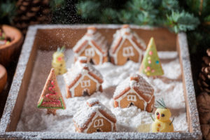 Cute and sweet Christmas gingerbread village with snowman and trees